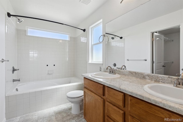 719 Elk Mountain Dr, Severance, CO 80550 - full bath with toilet, tiled shower / bath, and double vanity