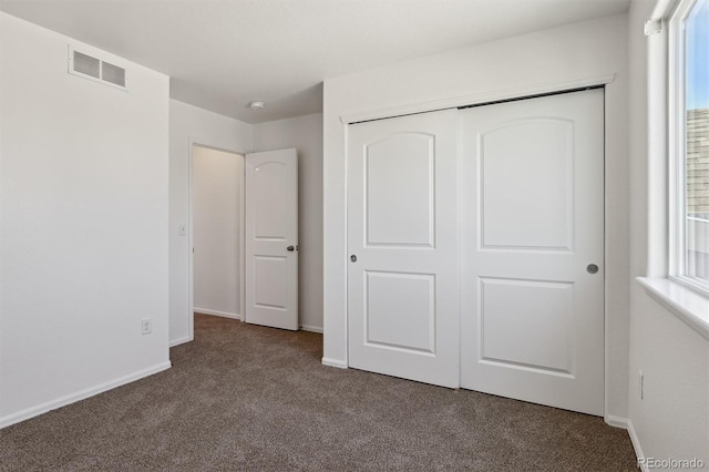 719 Elk Mountain Dr, Severance, CO 80550 - unfurnished bedroom featuring dark colored carpet, a closet, and baseboards