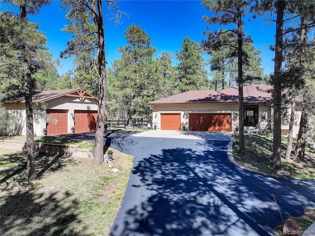 8890 Hodgen Rd, Colorado Springs, CO 80908 - exterior space featuring aphalt driveway, stucco siding, and an attached garage