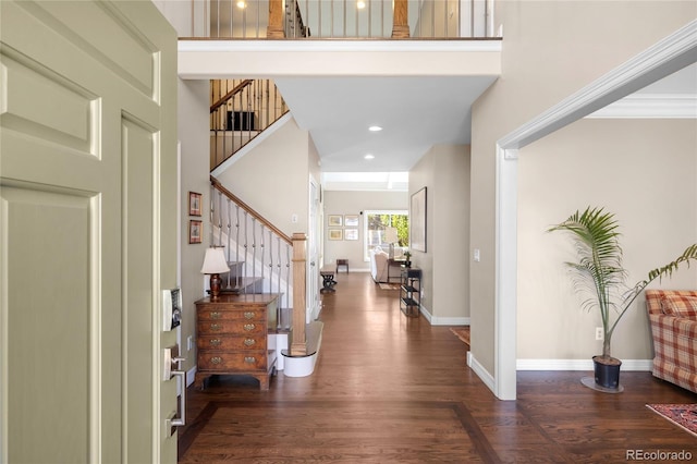 entrance foyer with baseboards, wood finished floors, recessed lighting, and stairs