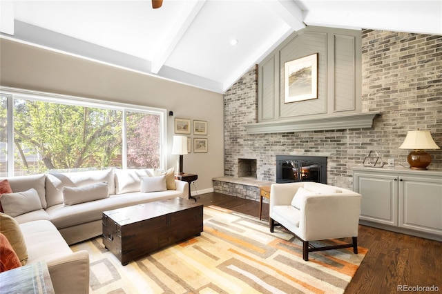 living area with high vaulted ceiling, light wood-type flooring, beamed ceiling, a fireplace, and baseboards
