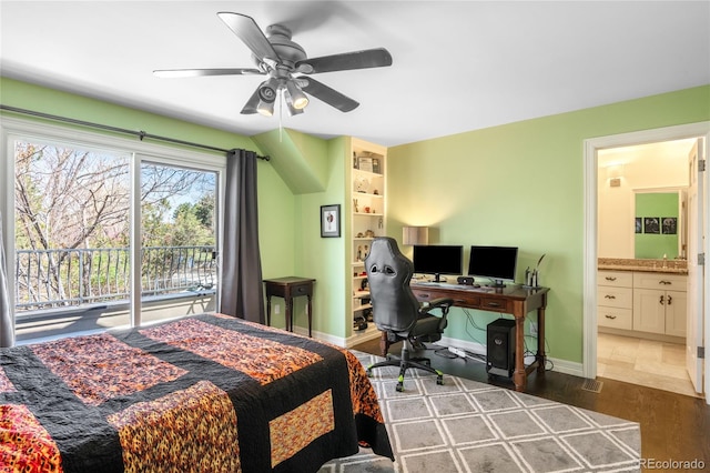 bedroom featuring baseboards, access to outside, dark wood-type flooring, and ensuite bathroom