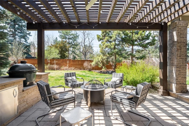 view of patio / terrace with grilling area, a fenced backyard, an outdoor living space with a fire pit, and a pergola