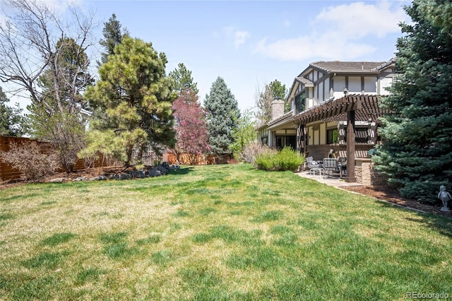 view of yard featuring fence, a pergola, and a patio area