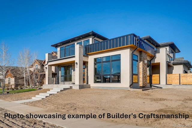 exterior space with a balcony and stucco siding