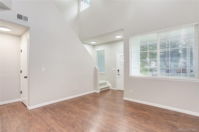 15828 Greenstone Ln, Parker, CO 80134 - foyer entrance featuring stairway, plenty of natural light, wood finished floors, and a towering ceiling