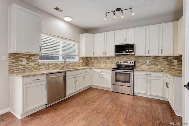 15828 Greenstone Ln, Parker, CO 80134 - kitchen featuring stainless steel appliances, a sink, and white cabinetry
