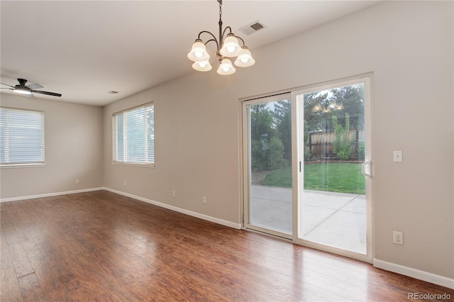 15828 Greenstone Ln, Parker, CO 80134 - empty room with healthy amount of natural light, a chandelier, wood finished floors, and baseboards