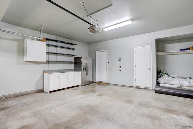 15828 Greenstone Ln, Parker, CO 80134 - garage with stainless steel fridge and a garage door opener