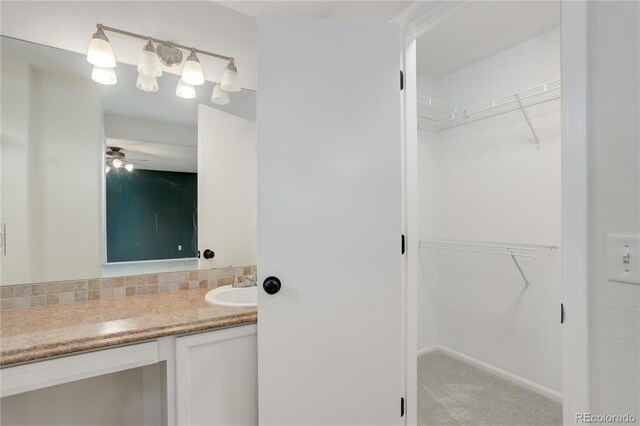 15828 Greenstone Ln, Parker, CO 80134 - bathroom featuring vanity, a walk in closet, and a ceiling fan
