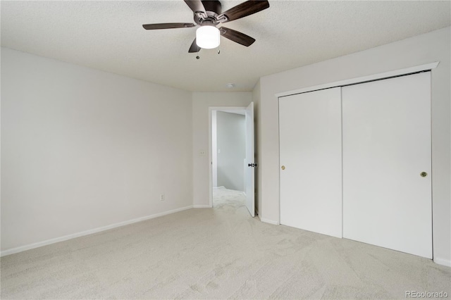 15828 Greenstone Ln, Parker, CO 80134 - unfurnished bedroom with light carpet, a closet, a textured ceiling, a ceiling fan, and baseboards