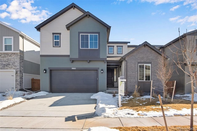 view of front of house with driveway, a garage, and brick siding