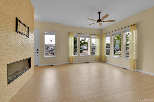 5154 Taft Ct, Wheat Ridge, CO 80033 - unfurnished living room featuring ceiling fan, a tiled fireplace, light wood-style flooring, plenty of natural light, and recessed lighting
