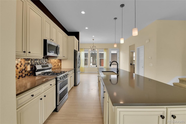 5154 Taft Ct, Wheat Ridge, CO 80033 - kitchen featuring stainless steel appliances, dark countertops, a large island with sink, decorative backsplash, and recessed lighting