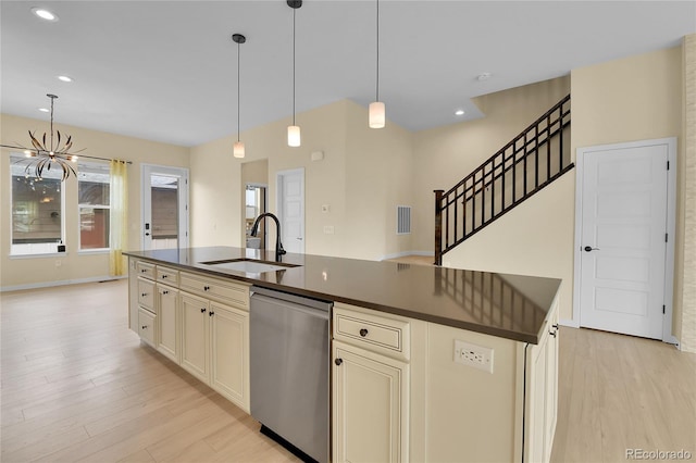 5154 Taft Ct, Wheat Ridge, CO 80033 - kitchen with dishwasher, dark countertops, cream cabinets, light wood finished floors, and recessed lighting