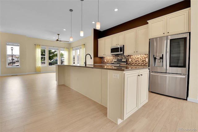 5154 Taft Ct, Wheat Ridge, CO 80033 - kitchen with stainless steel appliances, tasteful backsplash, light wood-style floors, recessed lighting, and ceiling fan