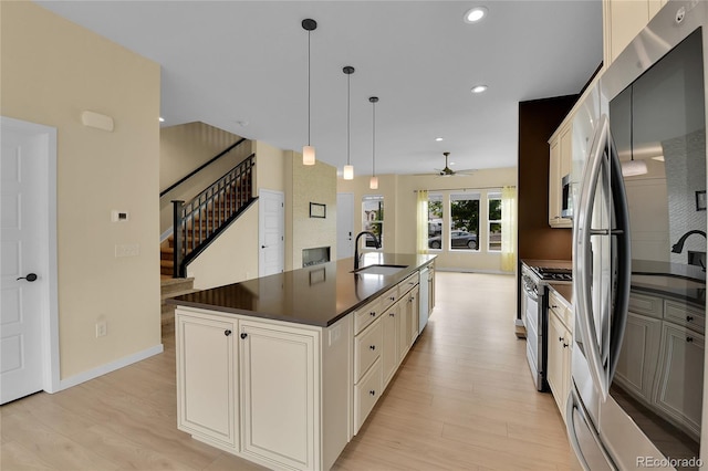 5154 Taft Ct, Wheat Ridge, CO 80033 - kitchen featuring stainless steel appliances, dark countertops, a ceiling fan, light wood-style flooring, and recessed lighting