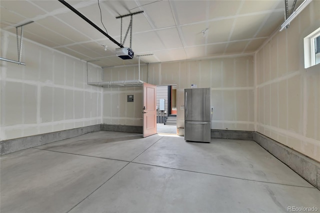 5154 Taft Ct, Wheat Ridge, CO 80033 - garage featuring a garage door opener and freestanding refrigerator