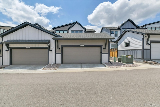 5154 Taft Ct, Wheat Ridge, CO 80033 - view of front of home with board and batten siding, a garage, roof with shingles, and concrete driveway