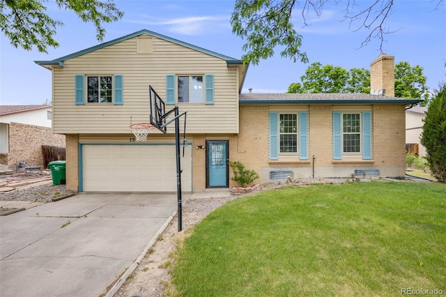 1549 S Evanston St, Aurora, CO 80012 - split level home with brick siding, a garage, a chimney, concrete driveway, and a front lawn
