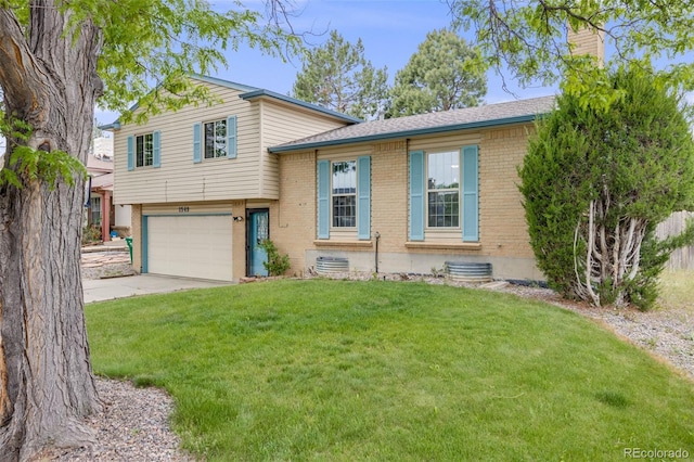1549 S Evanston St, Aurora, CO 80012 - tri-level home with brick siding, a garage, a front lawn, a chimney, and concrete driveway