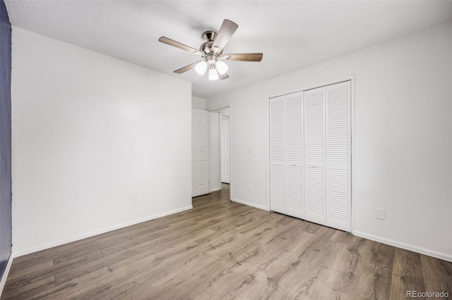 1549 S Evanston St, Aurora, CO 80012 - unfurnished bedroom featuring wood finished floors, a closet, baseboards, and ceiling fan