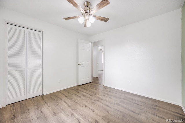 1549 S Evanston St, Aurora, CO 80012 - unfurnished bedroom with wood finished floors, baseboards, a closet, and a ceiling fan