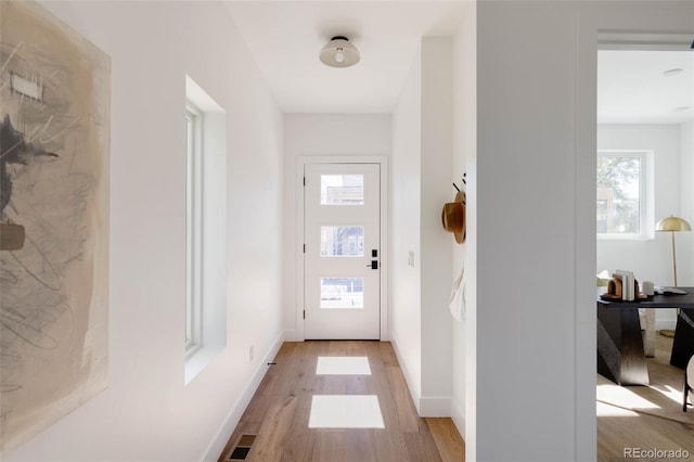 3435 W 17th Ave, Denver, CO 80204 - doorway featuring light wood-type flooring and baseboards