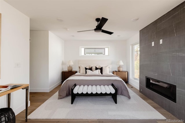 3435 W 17th Ave, Denver, CO 80204 - bedroom featuring wood finished floors, a ceiling fan, and a large fireplace