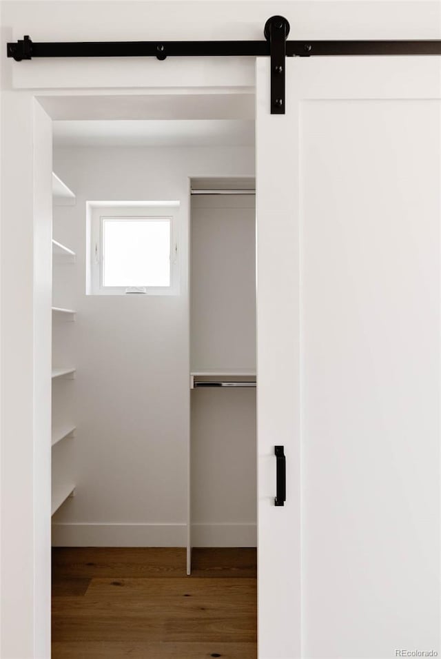 3435 W 17th Ave, Denver, CO 80204 - spacious closet featuring wood finished floors and a barn door