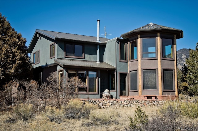 1507 Wagon Wheel Rd, Crestone, CO 81131 - rear view of house featuring stucco siding and metal roof