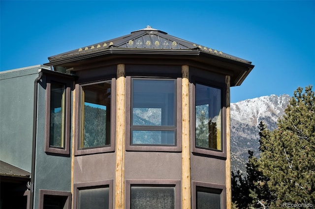 1507 Wagon Wheel Rd, Crestone, CO 81131 - view of property exterior with stucco siding, a mountain view, and metal roof