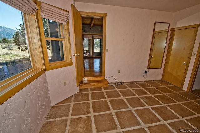 1507 Wagon Wheel Rd, Crestone, CO 81131 - interior space featuring plenty of natural light, a mountain view, and a textured wall