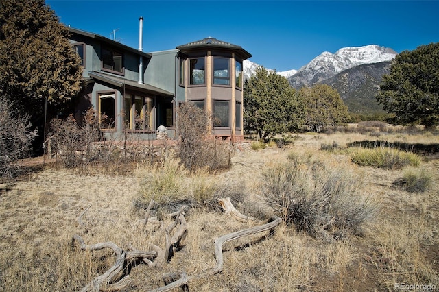 1507 Wagon Wheel Rd, Crestone, CO 81131 - rear view of house featuring a mountain view and stucco siding