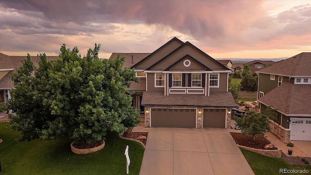 11691 Riverdale Dr, Parker, CO 80138 - view of front of property with concrete driveway, a garage, and stone siding