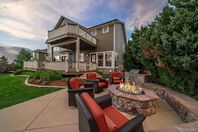 11691 Riverdale Dr, Parker, CO 80138 - patio / terrace with an outdoor fire pit, area for grilling, a yard, a patio area, and a wooden deck