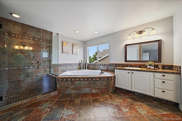 11691 Riverdale Dr, Parker, CO 80138 - full bath featuring vanity, a garden tub, a shower stall, recessed lighting, and stone finish flooring