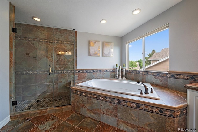 11691 Riverdale Dr, Parker, CO 80138 - bathroom featuring a bath, a shower stall, recessed lighting, vanity, and stone finish floors