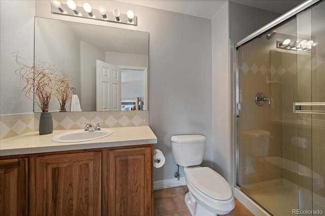 11691 Riverdale Dr, Parker, CO 80138 - bathroom featuring vanity, a stall shower, tile patterned floors, and tasteful backsplash