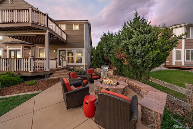 11691 Riverdale Dr, Parker, CO 80138 - patio terrace at dusk featuring a fire pit, a patio, and an outdoor kitchen