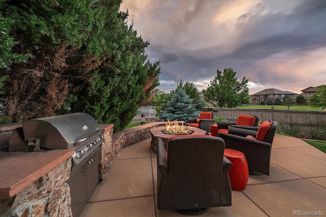 11691 Riverdale Dr, Parker, CO 80138 - view of patio with a fire pit and an outdoor kitchen