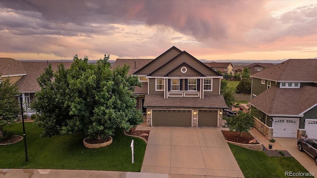 11691 Riverdale Dr, Parker, CO 80138 - view of front of home with concrete driveway, a garage, a front lawn, and stone siding