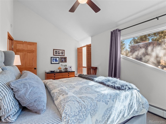 bedroom with lofted ceiling, baseboard heating, and a ceiling fan