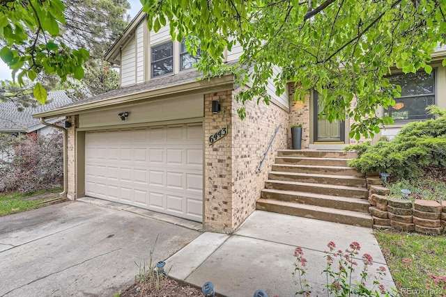6443 S Florence Way, Englewood, CO 80111 - view of front facade with a garage, brick siding, and driveway