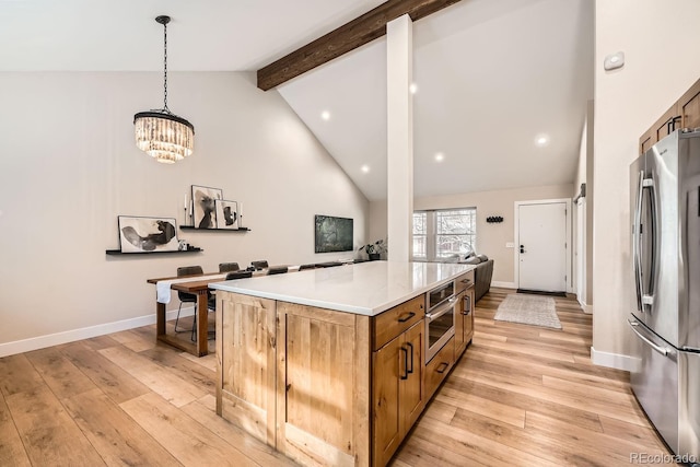6443 S Florence Way, Englewood, CO 80111 - kitchen with appliances with stainless steel finishes, beam ceiling, brown cabinets, light wood-style flooring, and a kitchen island