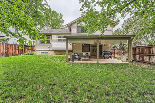 6443 S Florence Way, Englewood, CO 80111 - back of property featuring a fenced backyard, a patio area, and outdoor lounge area