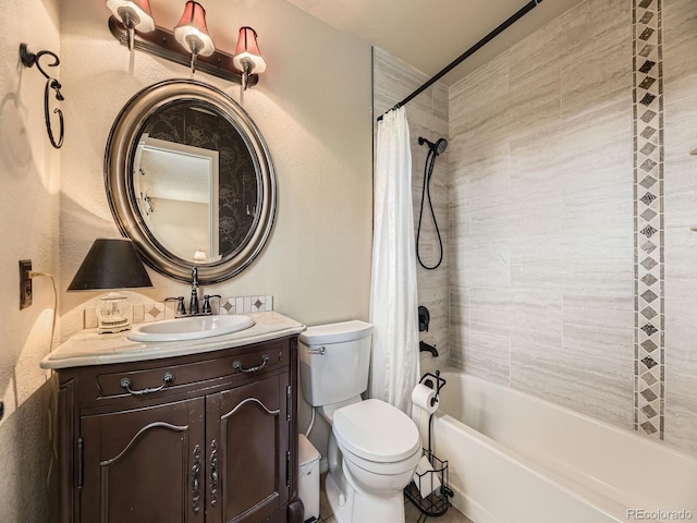 bathroom with toilet, shower / bath combo with shower curtain, vanity, and a textured wall