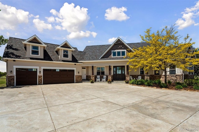 3048 Deer Creek Ranch Loop, Parker, CO 80138 - view of front facade with covered porch, stone siding, concrete driveway, and an attached garage