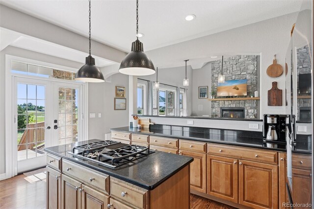 3048 Deer Creek Ranch Loop, Parker, CO 80138 - kitchen with black gas stovetop, french doors, plenty of natural light, and wood finished floors