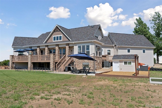 3048 Deer Creek Ranch Loop, Parker, CO 80138 - rear view of house with a deck, a patio area, a lawn, stone siding, and roof with shingles